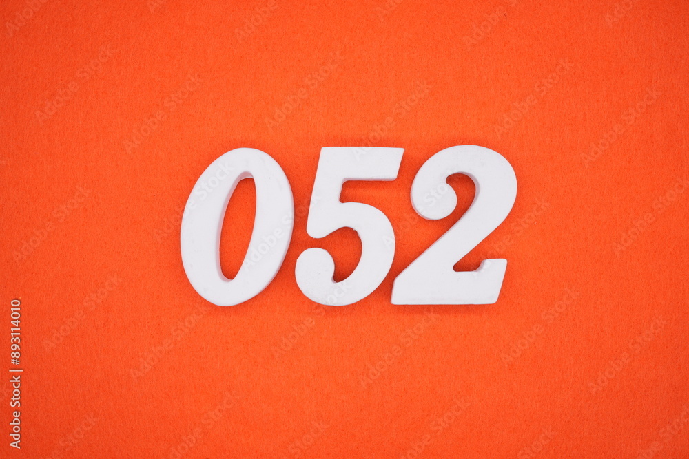 The numbers are made of white painted wood. Placed on the floor was orange paper. The numbers are made of white painted wood. Placed on the floor was orange paper.