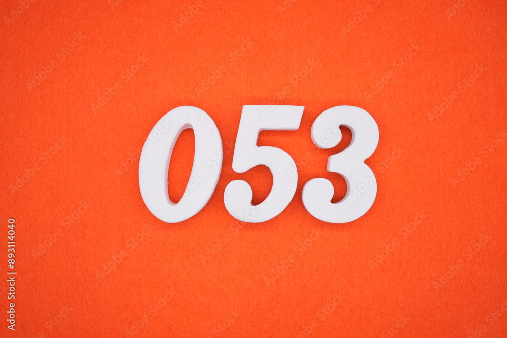 The numbers are made of white painted wood. Placed on the floor was orange paper. The numbers are made of white painted wood. Placed on the floor was orange paper.