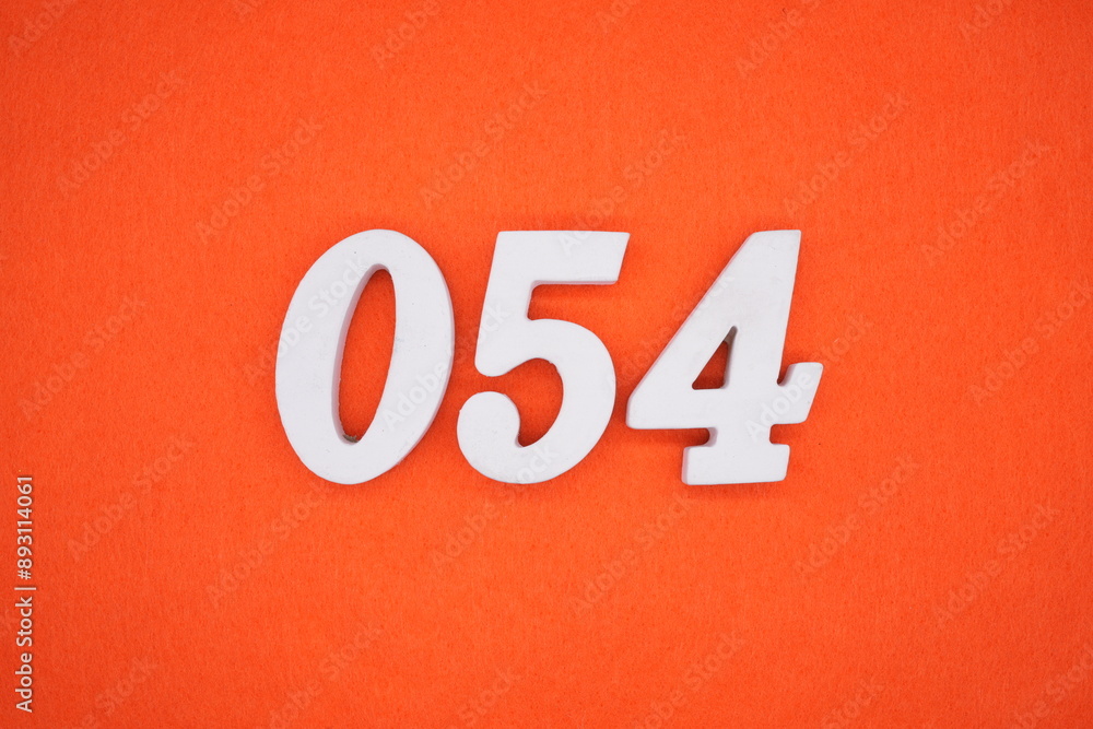 The numbers are made of white painted wood. Placed on the floor was orange paper. The numbers are made of white painted wood. Placed on the floor was orange paper.