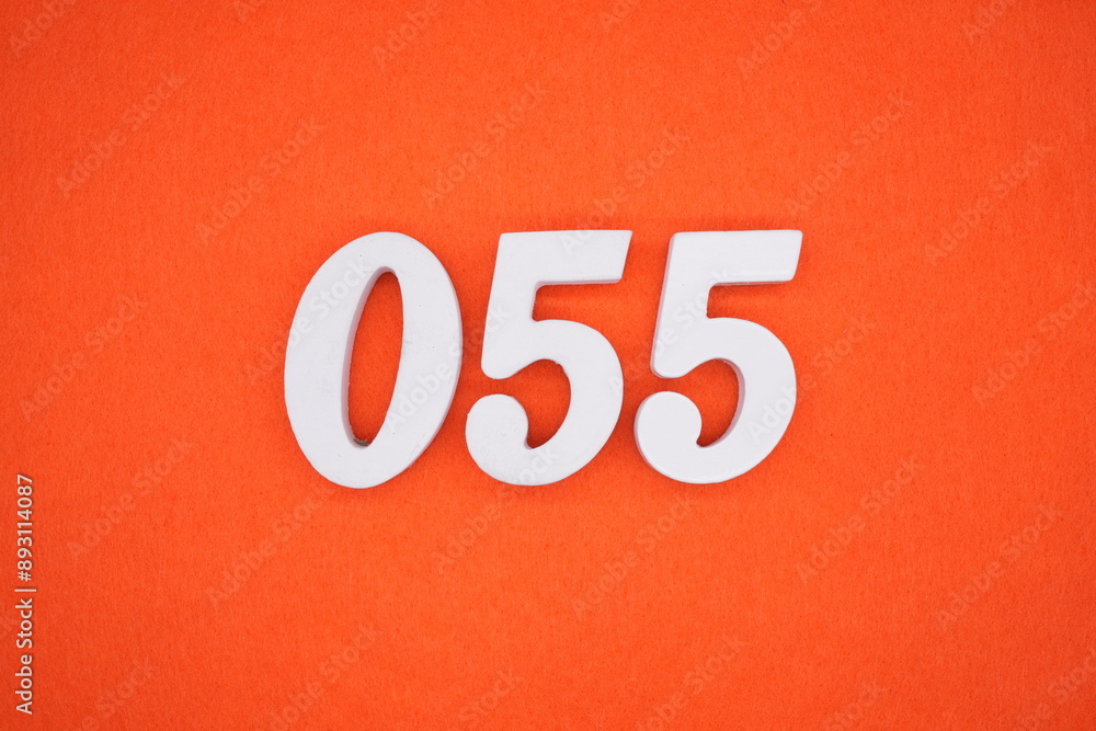 The numbers are made of white painted wood. Placed on the floor was orange paper. The numbers are made of white painted wood. Placed on the floor was orange paper.