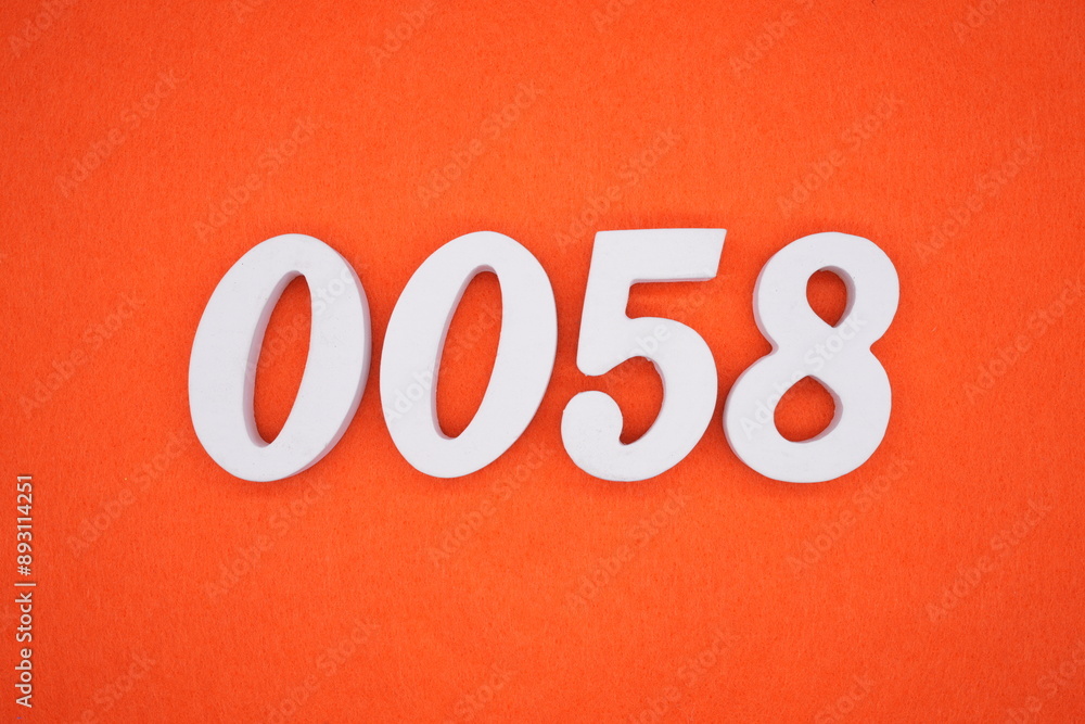 The numbers are made of white painted wood. Placed on the floor was orange paper. The numbers are made of white painted wood. Placed on the floor was orange paper.