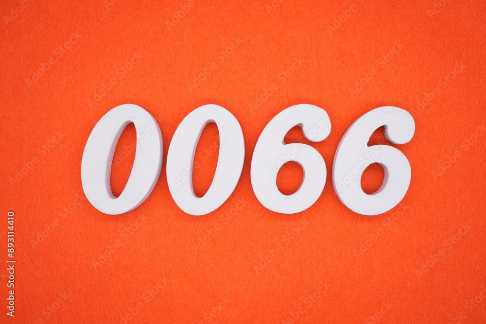The numbers are made of white painted wood. Placed on the floor was orange paper. The numbers are made of white painted wood. Placed on the floor was orange paper.