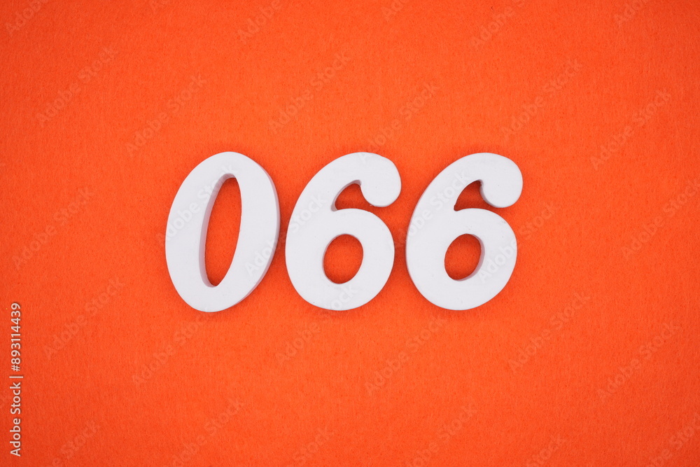 The numbers are made of white painted wood. Placed on the floor was orange paper. The numbers are made of white painted wood. Placed on the floor was orange paper.
