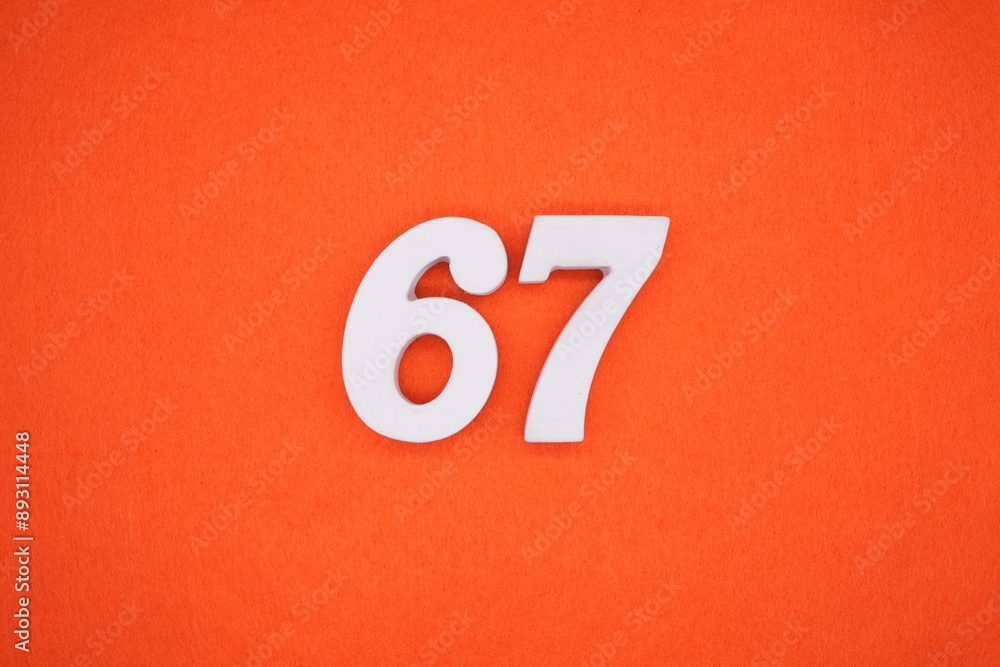 The numbers are made of white painted wood. Placed on the floor was orange paper. The numbers are made of white painted wood. Placed on the floor was orange paper.