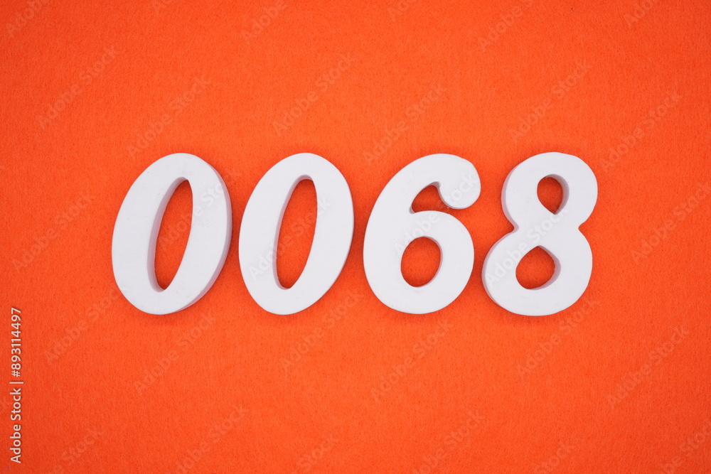 The numbers are made of white painted wood. Placed on the floor was orange paper. The numbers are made of white painted wood. Placed on the floor was orange paper.