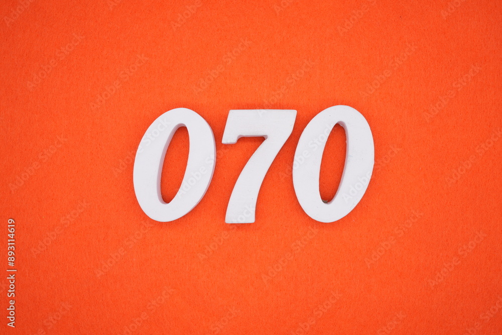 The numbers are made of white painted wood. Placed on the floor was orange paper. The numbers are made of white painted wood. Placed on the floor was orange paper.