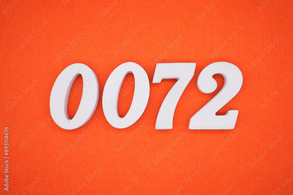 The numbers are made of white painted wood. Placed on the floor was orange paper. The numbers are made of white painted wood. Placed on the floor was orange paper.