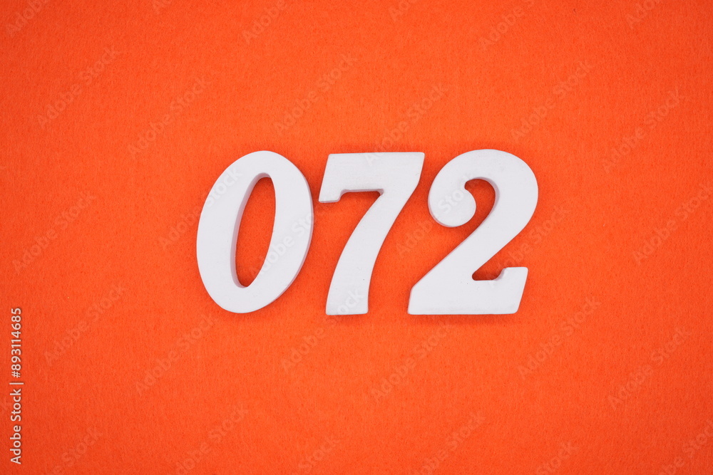 The numbers are made of white painted wood. Placed on the floor was orange paper. The numbers are made of white painted wood. Placed on the floor was orange paper.