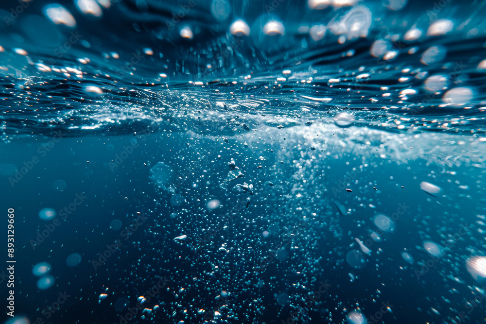 Underwater view with bubbles rising to the surface in a deep blue ocean. The image captures the serenity and mystery of the underwater world. Underwater view with bubbles rising to the surface in a deep blue ocean. The image captures the serenity and mystery of the underwater world.