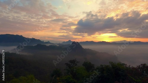 Time-lapse morning mist and clouds with twilight sky of High mountain in the background.