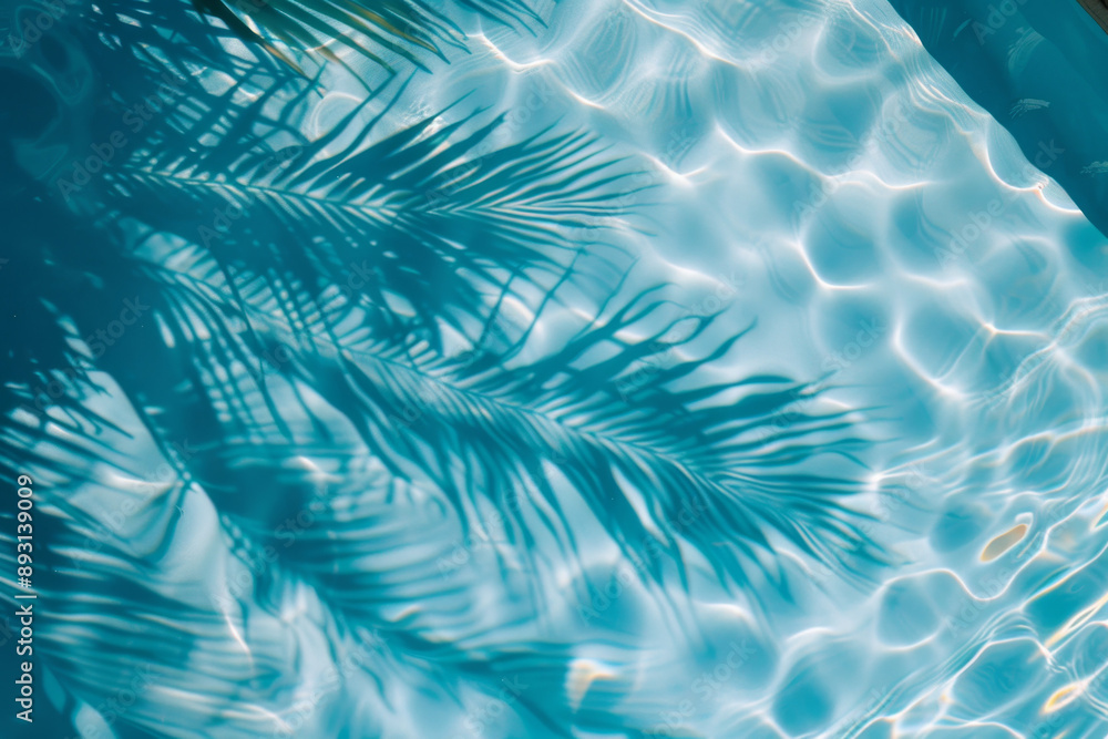 Abstract background with palm tree leaf shadow on water in swimming pool, summer concept Abstract background with palm tree leaf shadow on water in swimming pool, summer concept