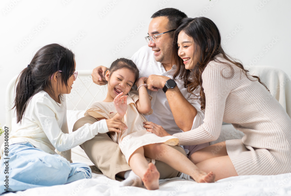 Portrait of enjoy happy love asian family father and mother holding hug cute little asian girl child smiling play and having fun moments good time, care, kid, support, insurance, child, at home Portrait of enjoy happy love asian family father and mother holding hug cute little asian girl child smiling play and having fun moments good time, care, kid, support, insurance, child, at home