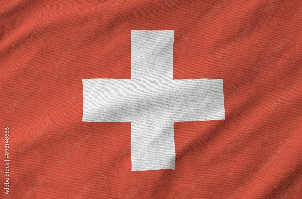 Switzerland flag depicted on folded wavy fabric of old cloth close up Switzerland flag depicted on folded wavy fabric of old cloth close up