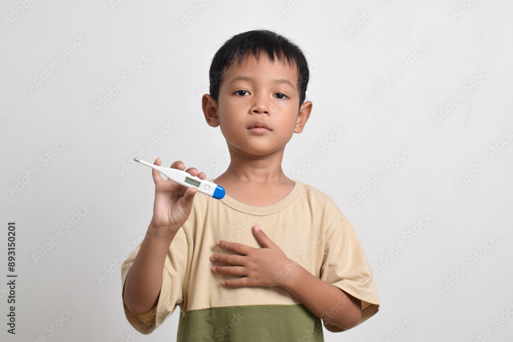 Little sick Asian boy holding thermometer isolated on white background. healthcare concept Little sick Asian boy holding thermometer isolated on white background. healthcare concept