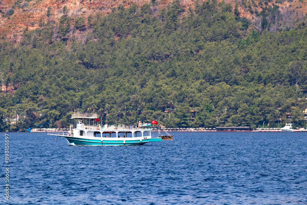 A tour boat in Marmaris. Boat that tours the bays for tourists. Summer vibes. A tour boat in Marmaris. Boat that tours the bays for tourists. Summer vibes.