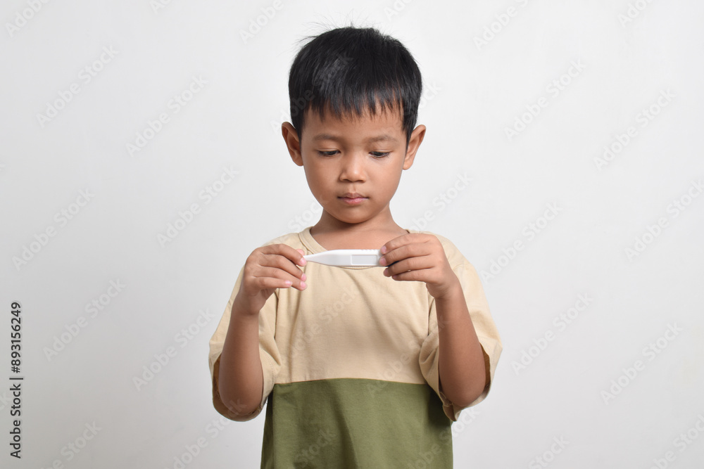 Little sick Asian boy holding thermometer isolated on white background. healthcare concept Little sick Asian boy holding thermometer isolated on white background. healthcare concept
