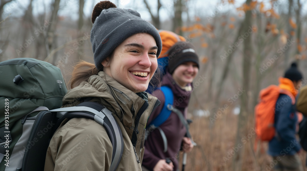 Smiling student hiking with friends on a winter day Smiling student hiking with friends on a winter day