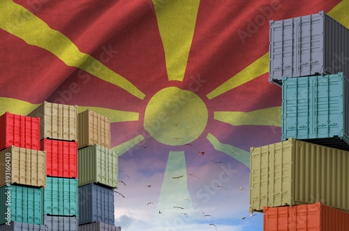 Macedonia flag and big stack of shipping cargo containers in docks with sky background close up photo