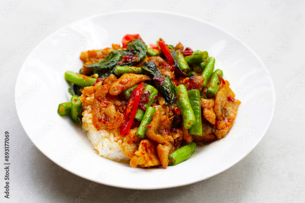 Rice topped with stir fried pork and red curry paste with yard-long bean Rice topped with stir fried pork and red curry paste with yard-long bean