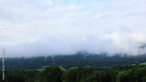 Cloud and fog timelapse above vallety with hill Klet at morning. Czech landscape photo