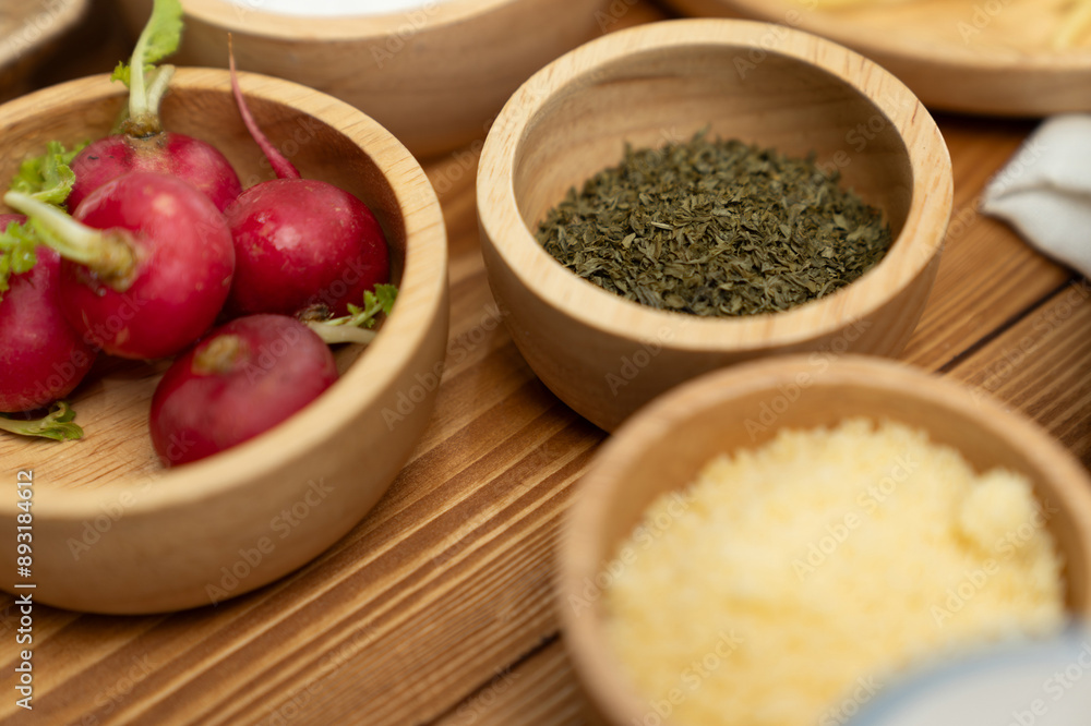 Close up in health food's Ingredients of special menu homemade cooking radish, garlic, salt, oregano, tomato and seasonings placing elements on preparing wooden table on blurred background. Postulate. Close up in health food's Ingredients of special menu homemade cooking radish, garlic, salt, oregano, tomato and seasonings placing elements on preparing wooden table on blurred background. Postulate.
