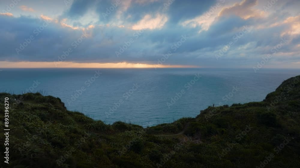 Rocky cliffs of Mercer Bay in the Waitakere Ranges at sunset. Piha, Auckland, New Zealand. Rocky cliffs of Mercer Bay in the Waitakere Ranges at sunset. Piha, Auckland, New Zealand.