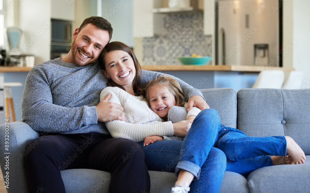 Man, woman and kid in home with portrait for wellness, bonding with support for relationship. Happy family, house and hug or care for father with pride, smile together in living room for security Man, woman and kid in home with portrait for wellness, bonding with support for relationship. Happy family, house and hug or care for father with pride, smile together in living room for security