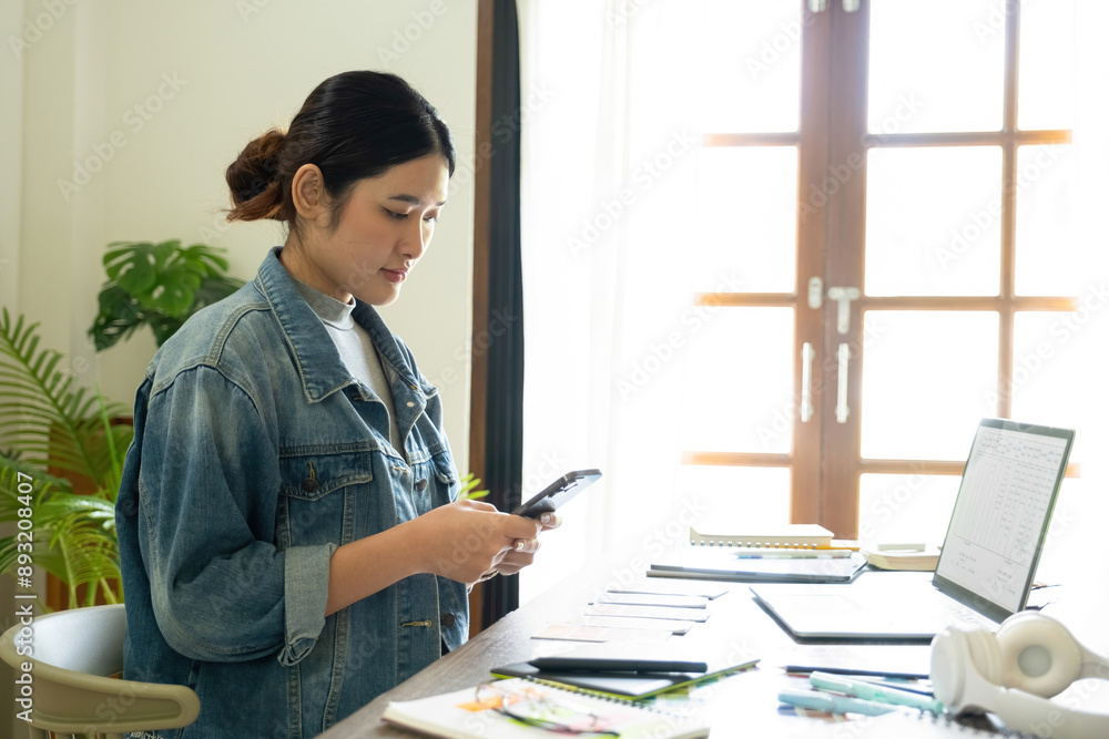 Young female architect uses smartphone to work. Young female architect uses smartphone to work.