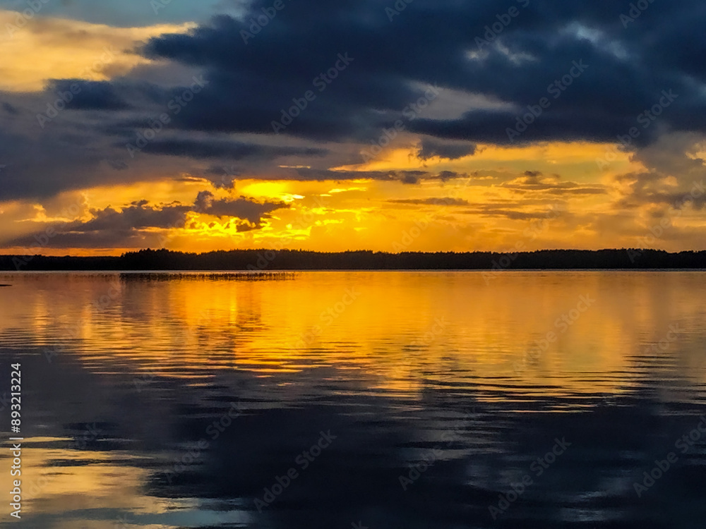 Naklejka premium Twilight Tranquility: The final moments of a Finnish sunset create a stunning silhouette against a vibrant, color-streaked sky.