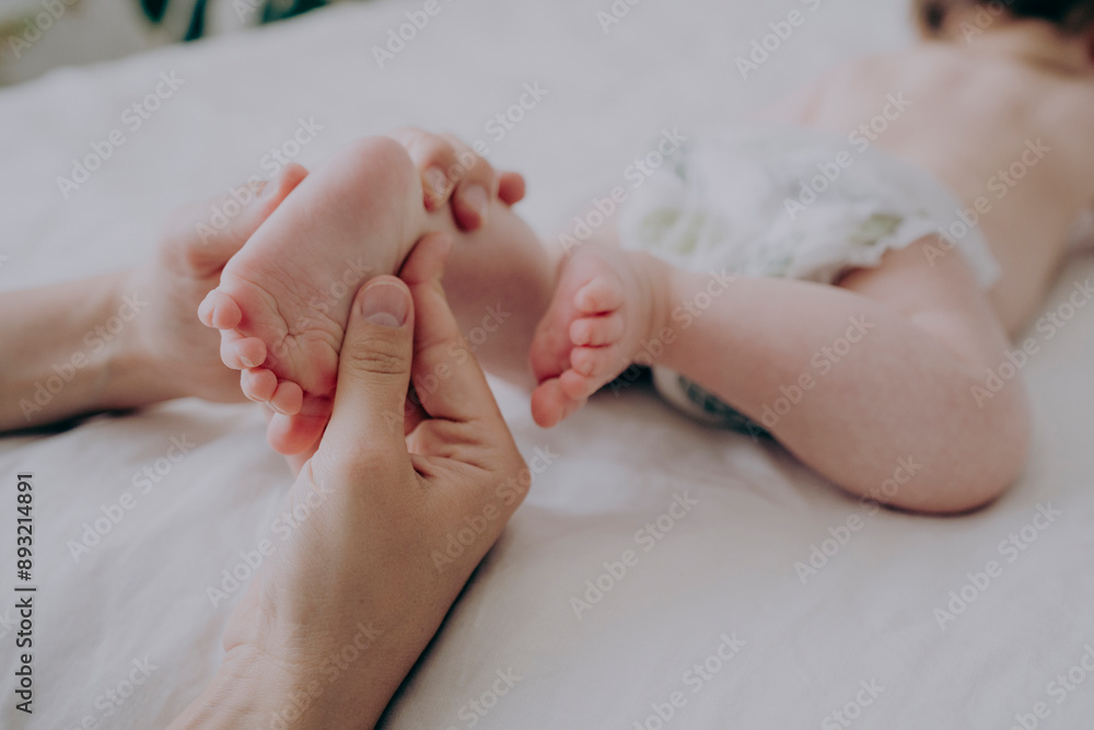 Hands of mother massaging baby's foot at home Hands of mother massaging baby's foot at home