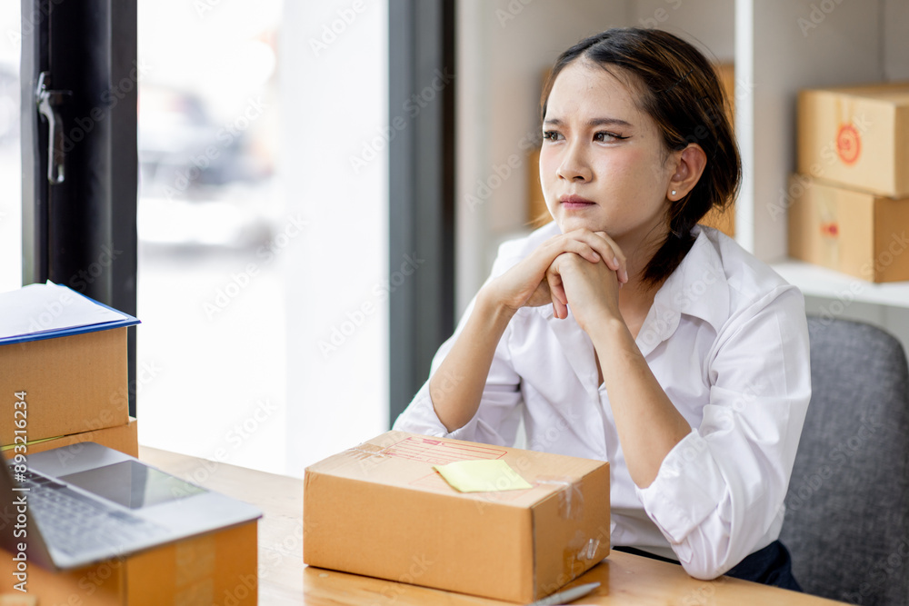 Asian woman think hard serious working of sme laptop computer at home selling online start up small business owner, e-commerce ideas concept. Asian woman think hard serious working of sme laptop computer at home selling online start up small business owner, e-commerce ideas concept.