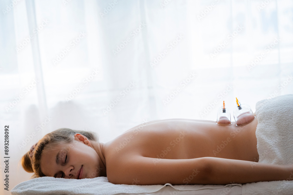 © Westend61 - Relaxed teenage girl lying on massage table with vacuum cups in health spa © Westend61 - Relaxed teenage girl lying on massage table with vacuum cups in health spa