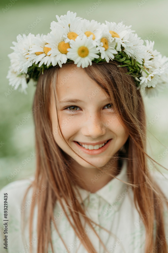 Smiling girl wearing fresh daisy flower wreath Smiling girl wearing fresh daisy flower wreath