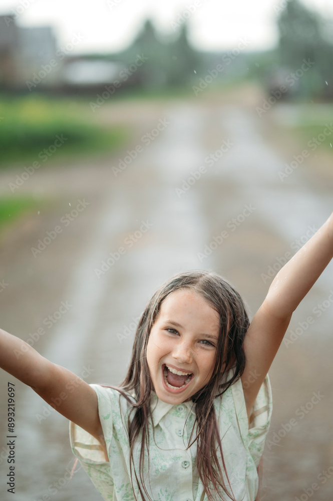 Cheerful girl enjoying rain at back yard Cheerful girl enjoying rain at back yard
