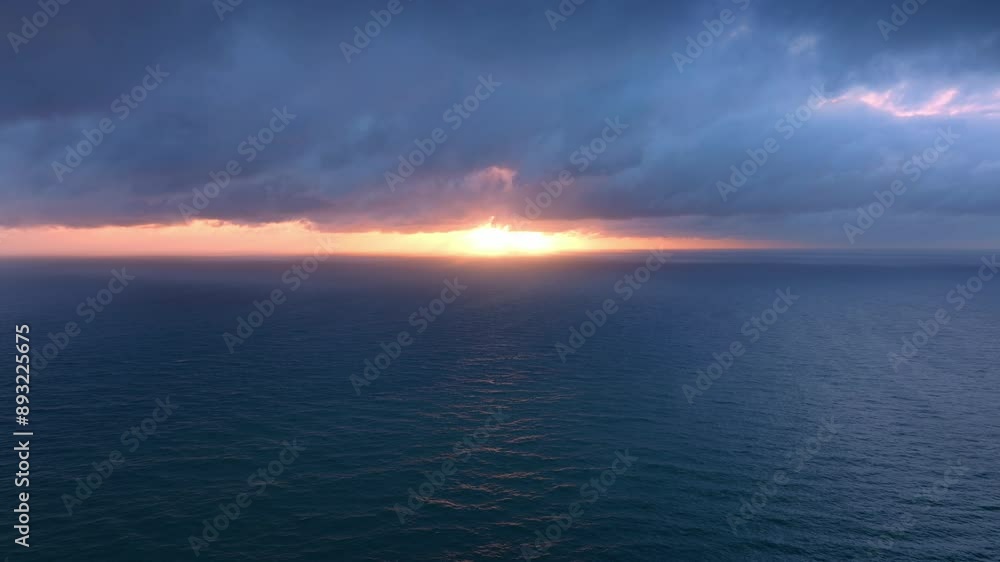 Tranquil dreamy sunset with heavy clouds off the coast piha, Auckland, New Zealand. Tranquil dreamy sunset with heavy clouds off the coast piha, Auckland, New Zealand.