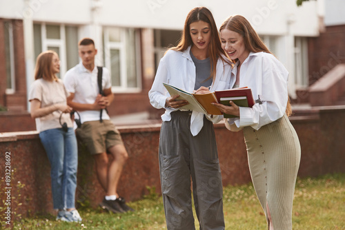 Bonding, positive emotions. Group of students are outside together