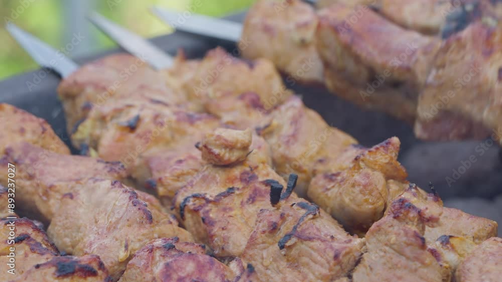 Delicious marinated meat skewers cooking on charcoal outdoors, making a tasty meal perfect for a gathering Delicious marinated meat skewers cooking on charcoal outdoors, making a tasty meal perfect for a gathering