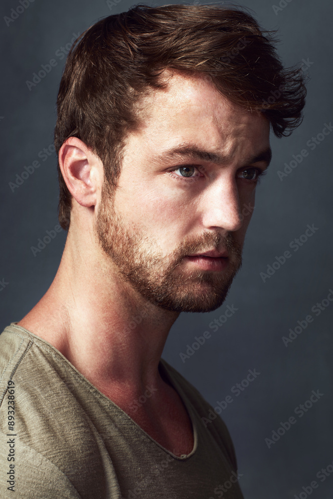 Fototapeta premium Man, thinking and serious in studio for reflection, contemplating future and gray background. Male person, remember and memory for perspective or insight, wondering and daydreaming of solution