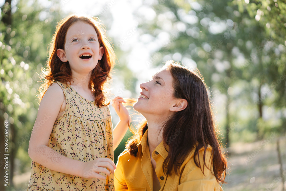 Happy mother and daughter spending leisure time in park Happy mother and daughter spending leisure time in park