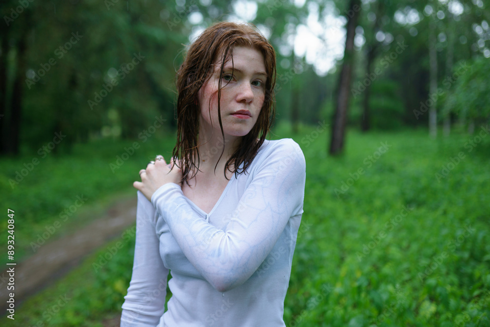 Woman with hand on shoulder in forest Woman with hand on shoulder in forest