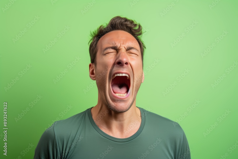 Close-up photo of a 40-year-old male, Caucasian, yawning with his mouth wide open, against a pastel green background
Close-up photo of a 40-year-old male, Caucasian, yawning with his mouth wide open, against a pastel green background