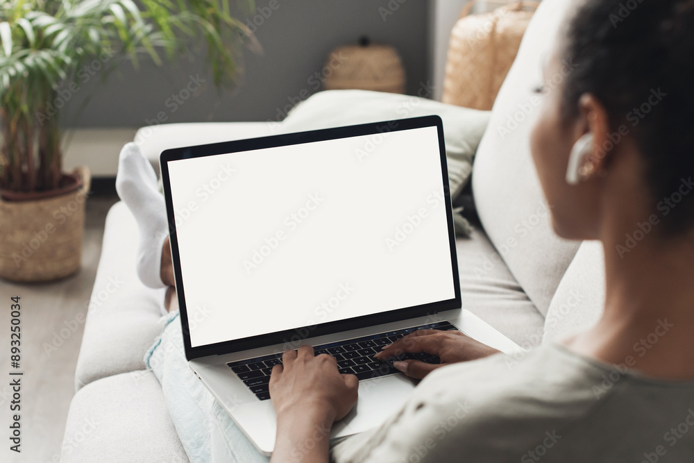 © kite_rin - Young woman using laptop computer at home. Blank empty white screen mock up. Freelance, student lifestyle, education, web conference, video call, technology and online shopping concept