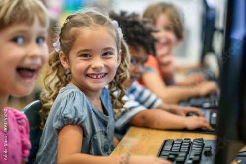 Diverse group of children sitting for learning computer at school classroom.