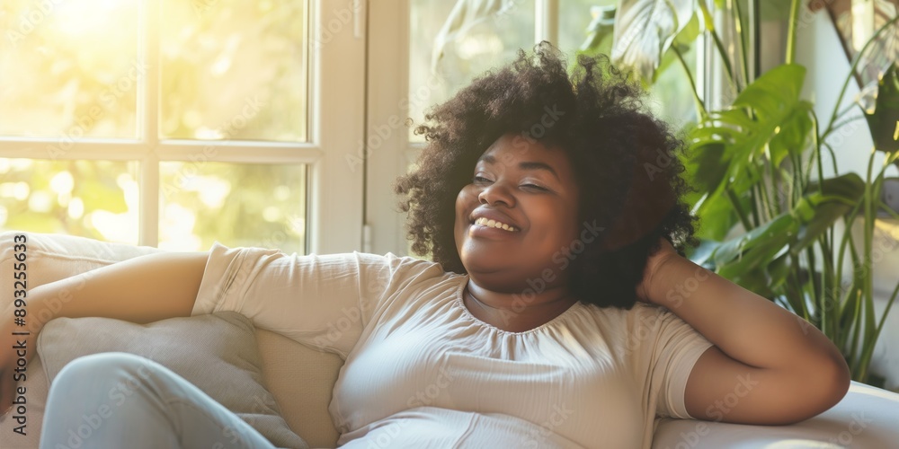 Happy overweight woman sitting on a comfortable sofa at home, enjoying peaceful relaxation and satisfaction. Happy overweight woman sitting on a comfortable sofa at home, enjoying peaceful relaxation and satisfaction.