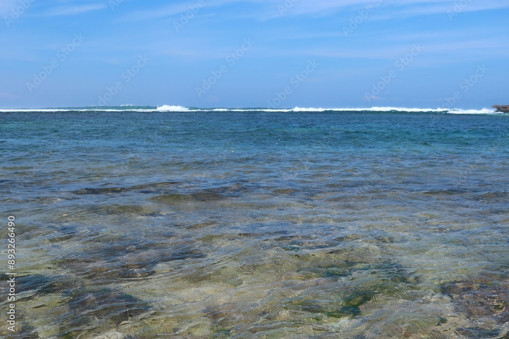 Beautiful sea view with blue sky and white clouds. Deep blue sea is very clear with small waves at Balaikambang beach malang Indonesia Beautiful sea view with blue sky and white clouds. Deep blue sea is very clear with small waves at Balaikambang beach malang Indonesia