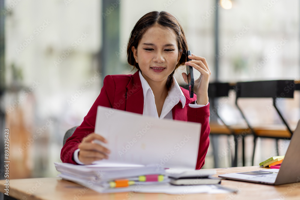 Cheerful business Asian woman accounting making telephone call share good news about project working in office workplace, business finance concept. Cheerful business Asian woman accounting making telephone call share good news about project working in office workplace, business finance concept.