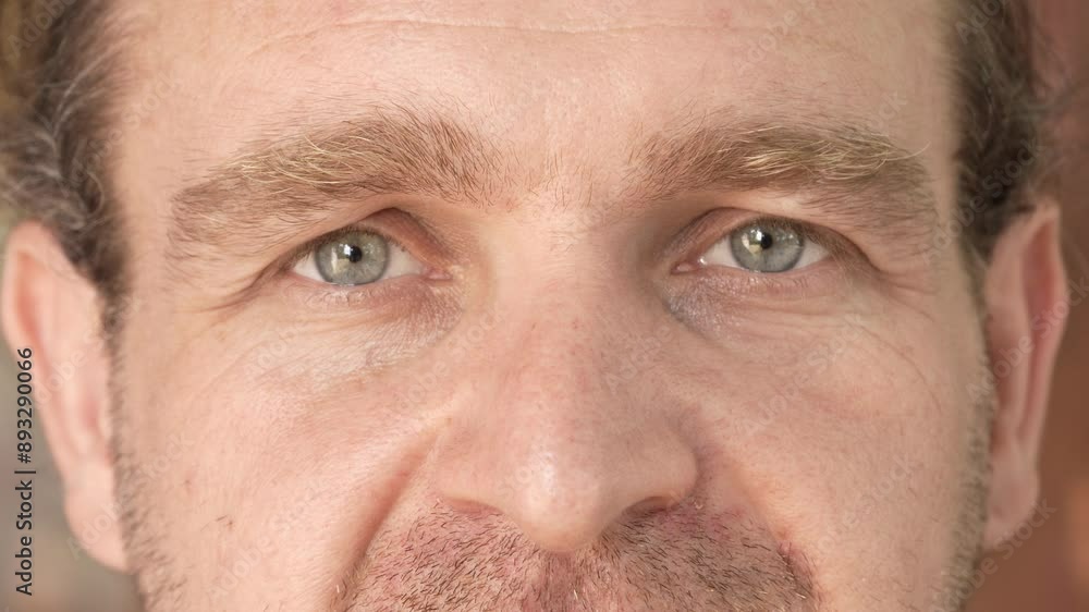 The look of a man with gray eyes. Close-up. Slow motion. High quality 4k footage The look of a man with gray eyes. Close-up. Slow motion. High quality 4k footage