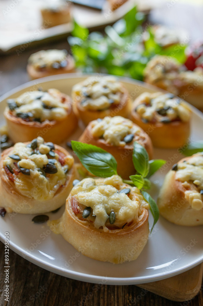 Hearty filled yeast rolls with ham, cheese and pumpkin seeds. Delicious party food or snack Hearty filled yeast rolls with ham, cheese and pumpkin seeds. Delicious party food or snack