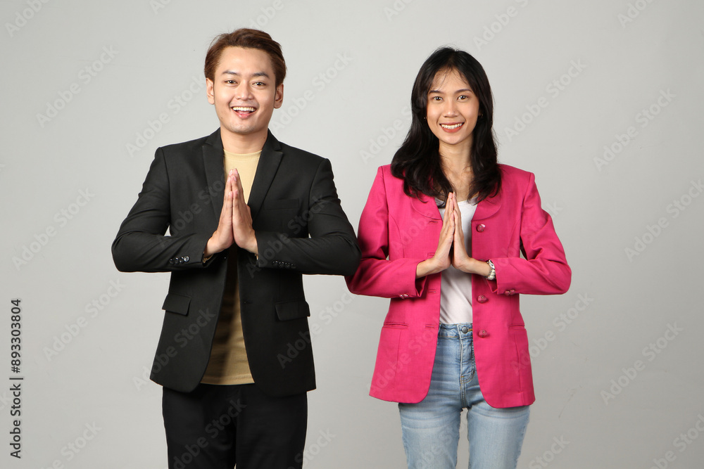 Portrait of successful Asian business man and business woman with greeting hand gesture on isolated background Portrait of successful Asian business man and business woman with greeting hand gesture on isolated background