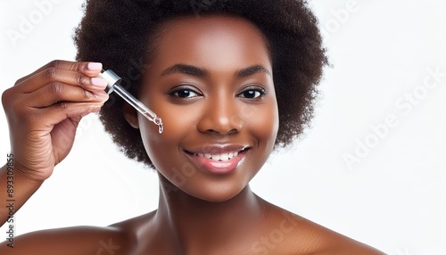 Brown Skinned Woman holding a Pipette with Skincare Serum - Applying Serum to her Face - Hyaluronic Acid, Anti Aging, Moisturiser, Repair, Hydrating, Vitamin, Ascorbic, Retinol, Exfoliant, Azelaic